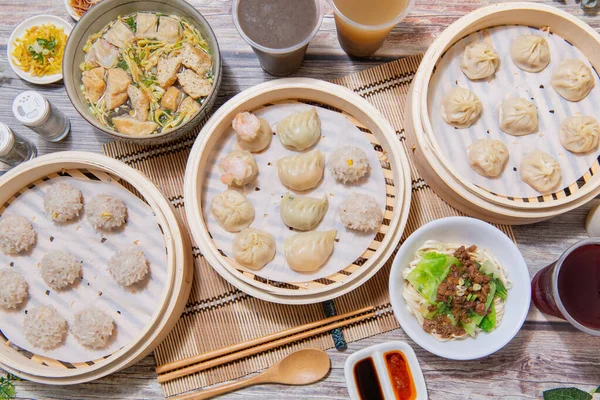 Steamed xiaolongbao and steamed dumplings served in a traditional steaming basket