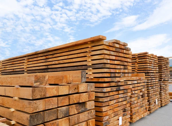 Stack of lumber and planks in a lumber warehouse outdoors