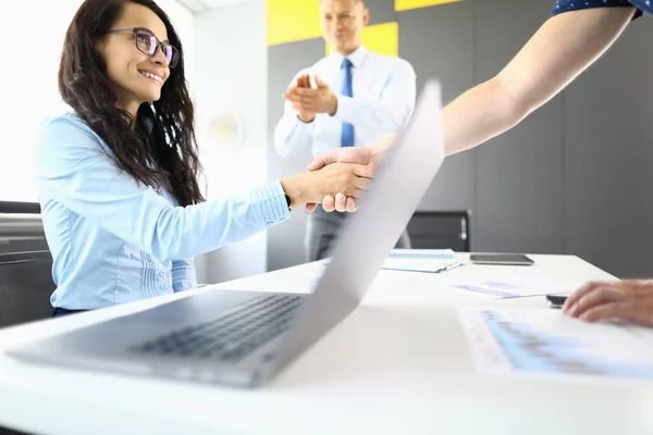 Businesswoman and partners in office shake hands and smil — Stock Photo, Image
