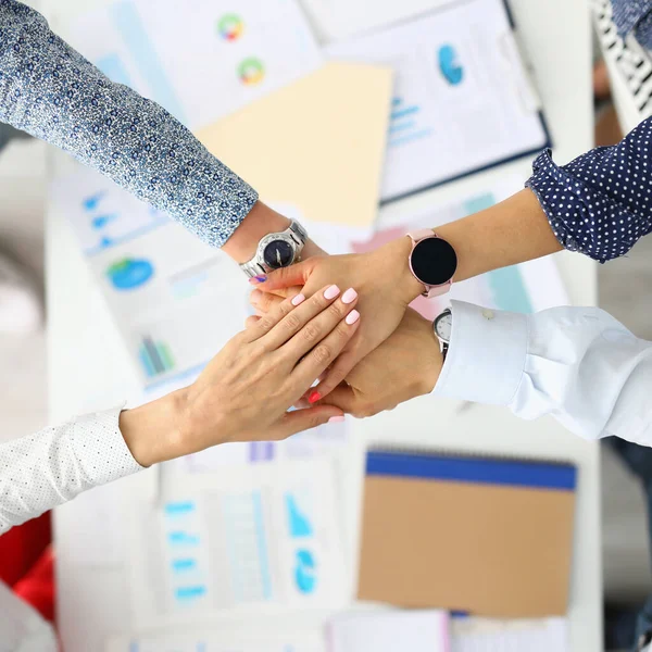 Business employees folded their hands together over work table. — Stock Photo, Image