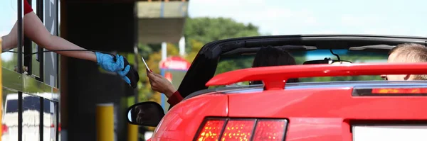 Mujer en el coche paga con una tarjeta bancaria en la cafetería de comida rápida. — Foto de Stock