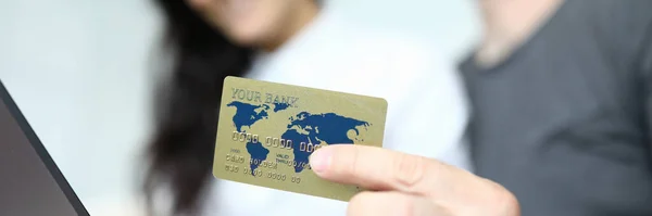 Credit bank card on the background of man and woman.