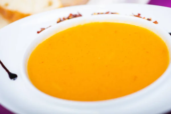 Lentil soup in a white plate on the table in a restaurant, served for guests. Close-up and details. Tasty food. Soft focus. — Stock Image Lentil Soup White Plate Table Restaurant Served Guests Close Details Royalty Free Stock Images