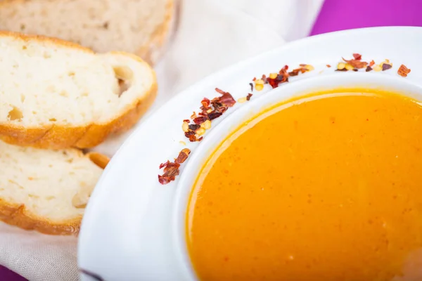 Lentil soup in a white plate on the table in a restaurant, served for guests. Close-up and details. Tasty food. Soft focus. — Stock Image Lentil Soup White Plate Table Restaurant Served Guests Close Details Stock Picture