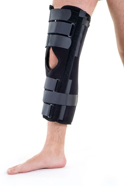 Man Wearing Leg Brace in Studio — Stock Photo, Image