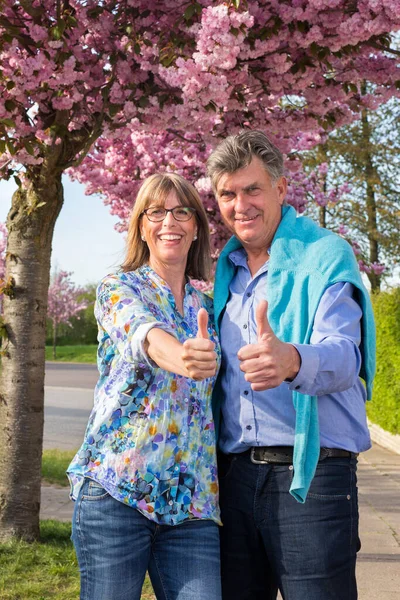 Positive Happy Senior Couple Giving Thumbs Stand Arm Arm Tree — Stock Photo, Image