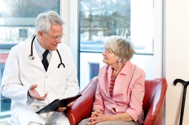 Male doctor in consultation with a senior patient. 