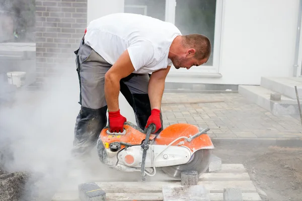 Construction worker with concrete saw — Stock Photo, Image