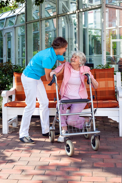 Woman being helped by care assistant
