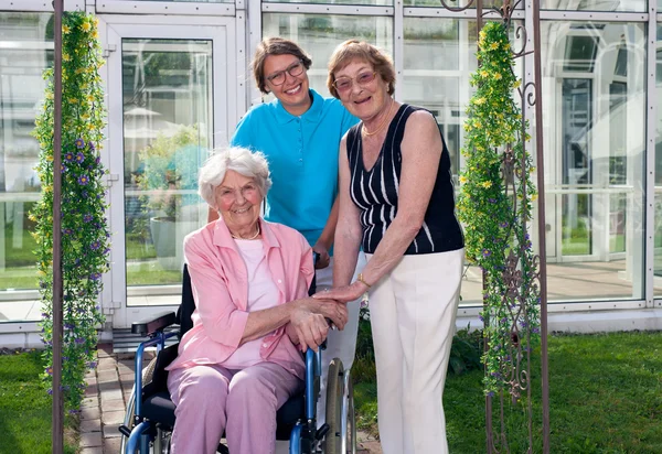 Care Takers and Patient on Wheel Chair — Stock Photo, Image