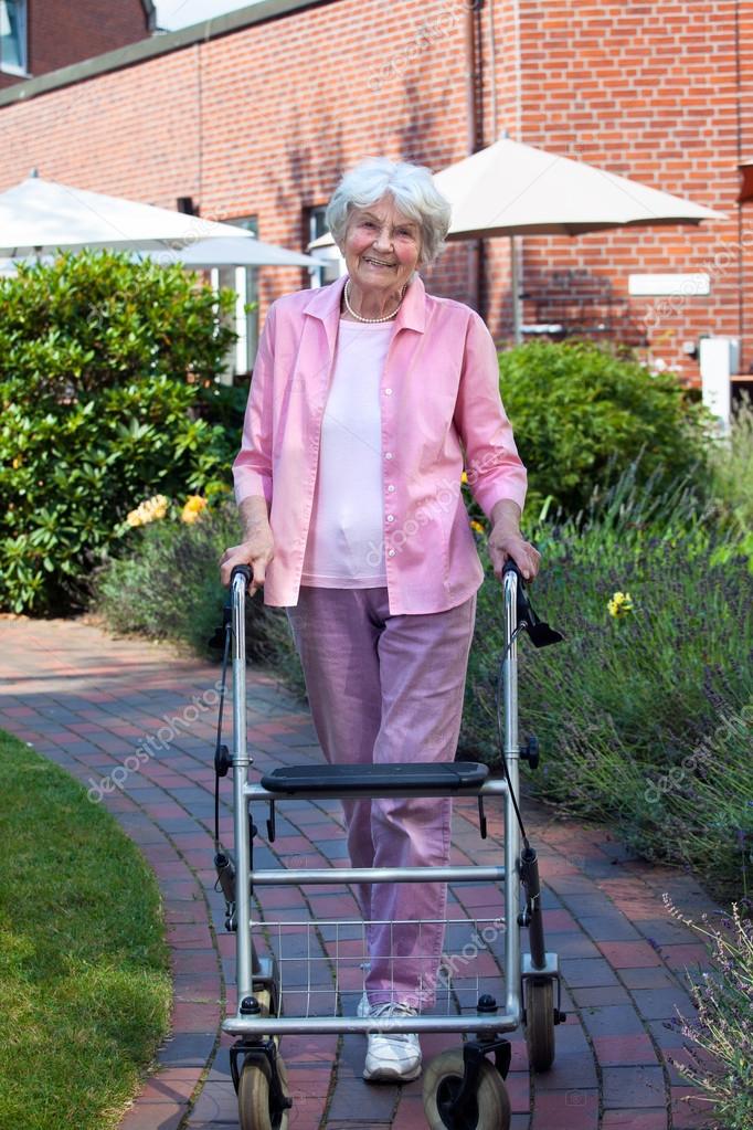 Elderly lady using walker Stock Photo by ©belahoche 65102335
