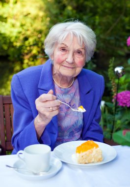Senior Woman Sitting at Garden clipart
