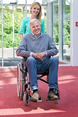 Nurse Pushing Senior Man