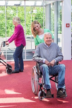 Nurse Pushing Senior Man