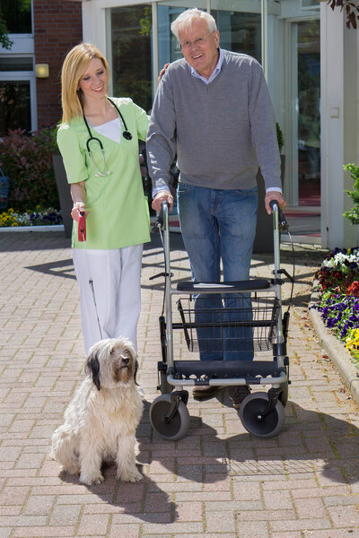 Nurse Holding onto Arm of Senior Man