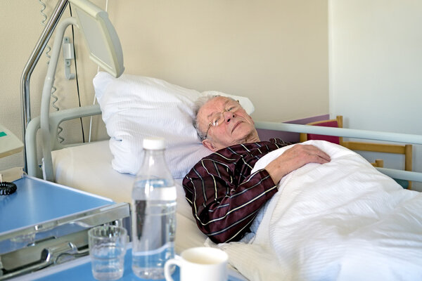 man recuperating in a hospital lying