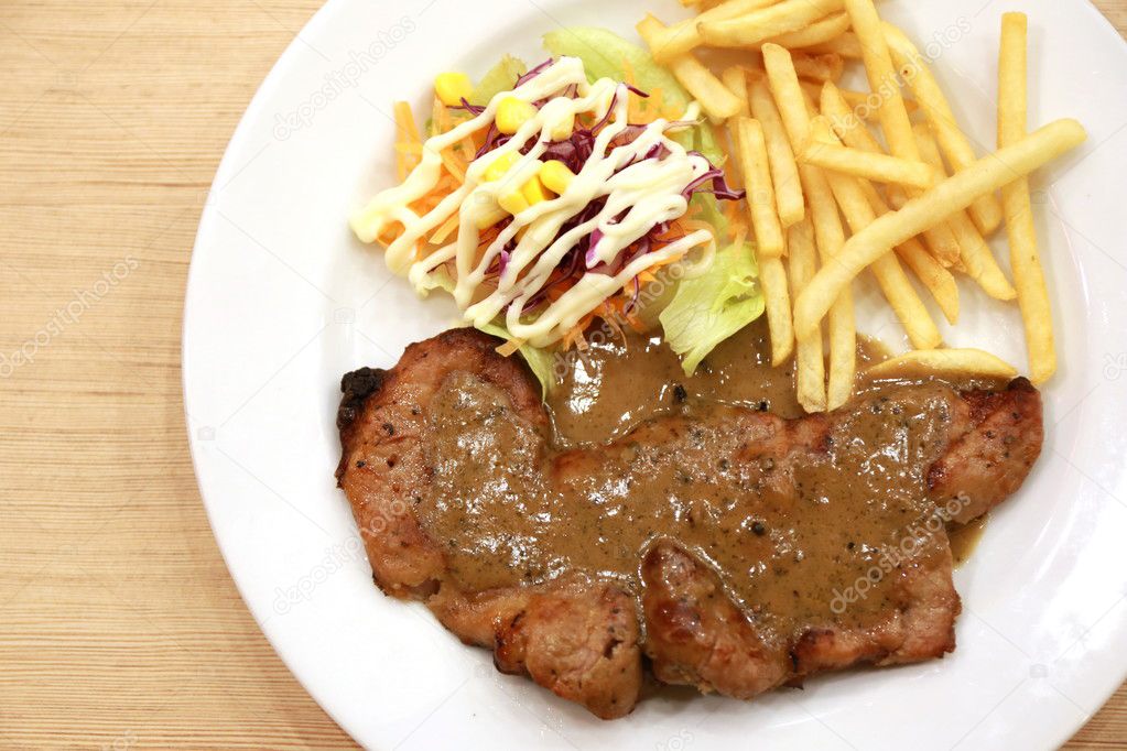 pork stake with french fried on plate