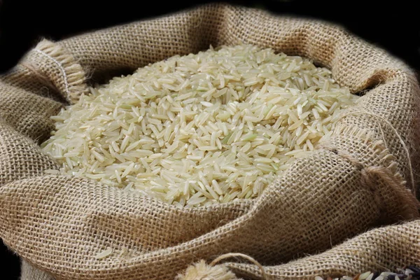 Close up organic rice in sack bag — Stock Photo, Image