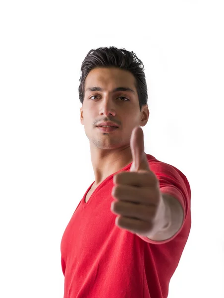 Young man doing thumb up sign — Stock Photo, Image