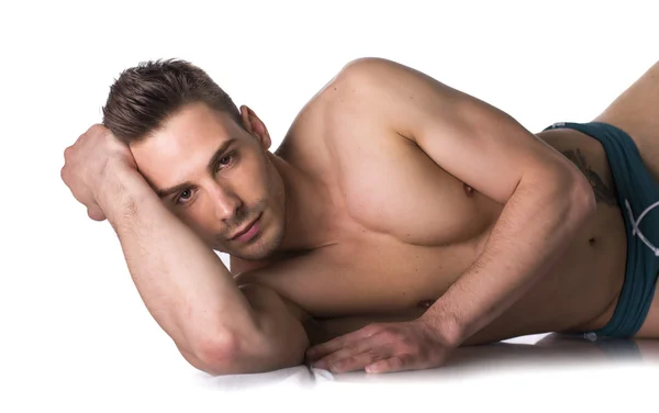 Cute expression, naked young man on white sheets — Stock Photo, Image