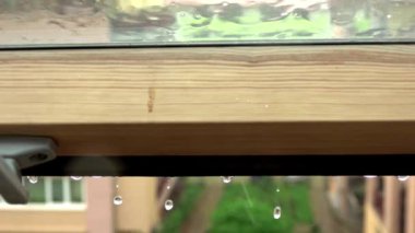 Heavy rain pouring on a building roof