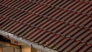 Heavy rain pouring on a building roof