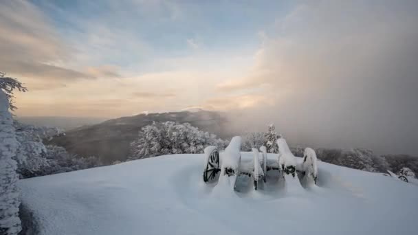 古い大砲の上に美しい高速移動霧と時間経過ビデオシフカ記念碑と日の出時のバルカン山脈の雪に覆われた山の斜面 — ストック動画