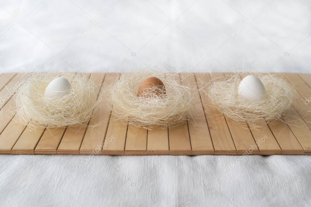 Easter concept. Easter decoration with eggs in natural color on a bamboo mat