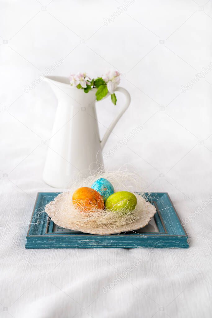 Easter concept. Easter decoration with painted and unpained easter eggs on a white background