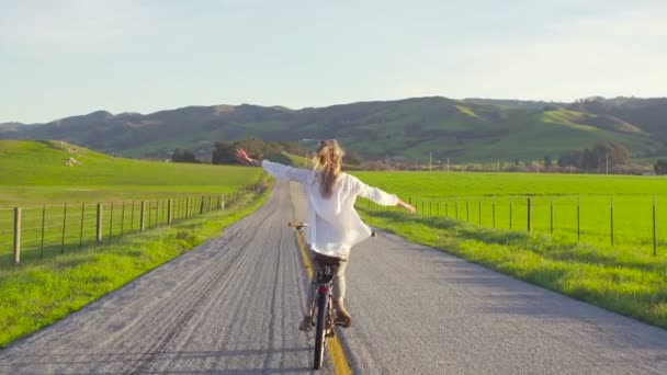 Boldog Lány Lovaglás Kerékpár Road Kezével Levegő Naplementekor — Stock videók