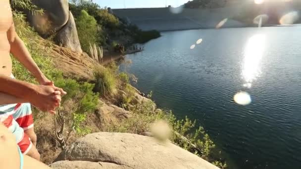 Happy Young Adult Couple Holding Hands Jumping Lake — Stock Video