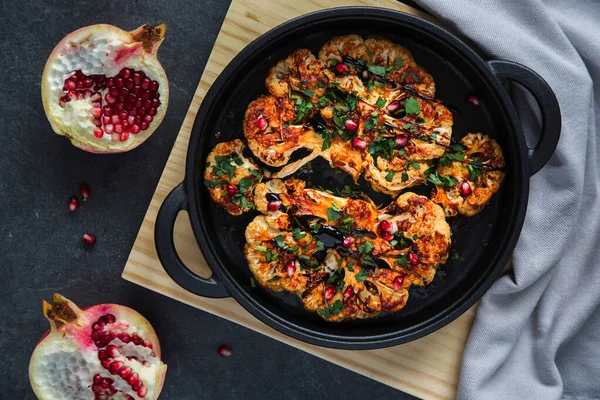 Roasted cauliflower steak with herbs.  Healthy eating, plant based meat substitute concept.