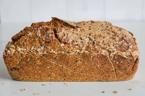 Rectangular loave of bread, traditional sourdough bread on light background. Concept of traditional leavened bread baking methods. Healthy food.