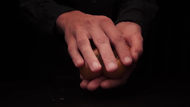 Mens hands offer to hold small yellow cherry tomatoes on a dark background — Stock Video