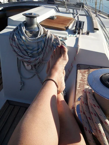 Caucasian woman relaxes on the sofa of her sailboat — Stock Photo, Image