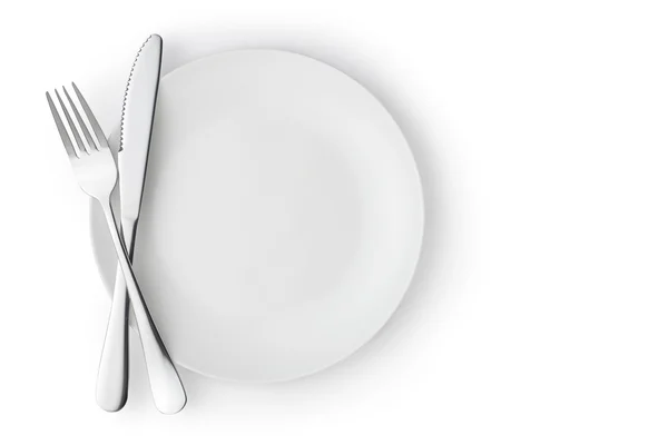 Fork and knife on empty plate — Stock Photo, Image