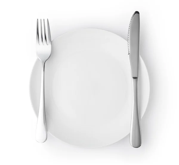 Fork and knife on empty plate — Stock Photo, Image