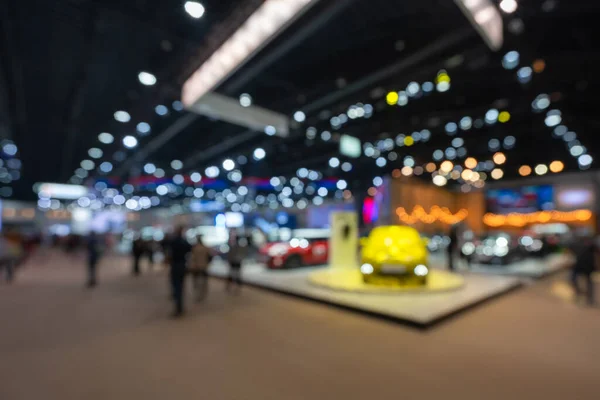 Abstract blurred image of people in cars exhibition show including activities and innovative automotive exhibitions at display in 42th Bangkok International Motor Show 2021 Nonthaburi, Thailand. Blurred for background conecpt.