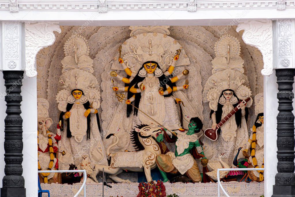 Goddess Durga idol at decorated Durga Puja pandal, shot at colored light, in Kolkata, West Bengal, India. Durga Puja is biggest religious festival of Hinduism and is now celebrated worldwide.