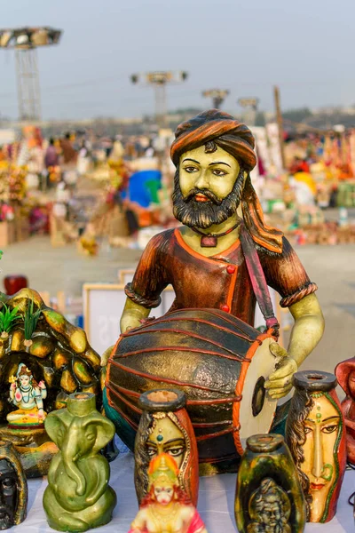 Beautiful handmade dolls of miniature folk musicians performing in a band of classical Indian music is displayed in a shop for sale. Indian handicraft.