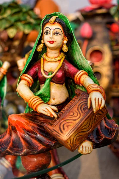 Beautiful handmade dolls of miniature folk musicians performing in a band of classical Indian music is displayed in a shop for sale. Indian handicraft.