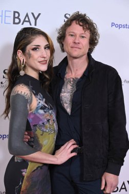 Burbank, CA USA. 10 Aralık 2025. Sprite Taylor ve Guy Wilson, The Bay 10. Sezon Prömiyer Gösterimi