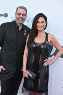 Hollywood, CA USA. 1 Şubat 2026. Paul Debevec ve Tia Carrere, Janie Grammy Ödül Töreni için 7.