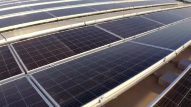 Elektrik üreten fabrikanın çatısındaki güneş panellerinin insansız hava aracı görüntüsü. Yeşil enerji