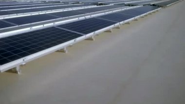 Elektrik üreten fabrikanın çatısındaki güneş panellerinin insansız hava aracı görüntüsü. Yeşil enerji