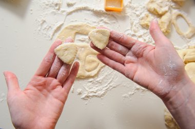 Female hands making cookies from fresh dough