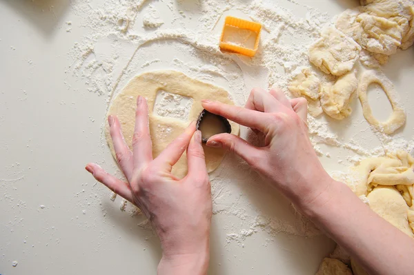 Female hands making cookies from fresh dough