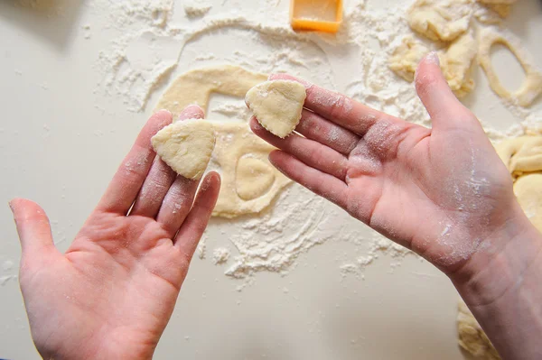 Female hands making cookies from fresh dough