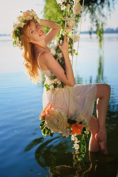 Mädchen auf Schaukel über Fluss — Stockfoto