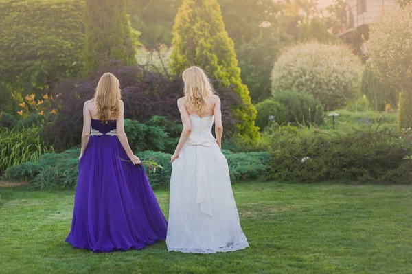 Bride and bridesmaid outside